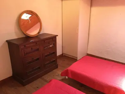 a bedroom with a dresser with a mirror on it at typical provencal farm in an exceptional natural site, the alpilles park - 8 people. in Maussane-les-Alpilles
