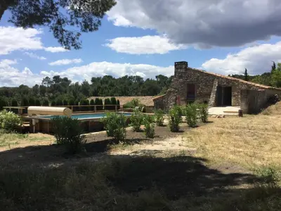a stone house with a swimming pool in a field at typical provencal farm in an exceptional natural site, the alpilles park - 8 people. in Maussane-les-Alpilles