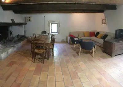 a living room with a couch and a table at typical provencal farm in an exceptional natural site, the alpilles park - 8 people. in Maussane-les-Alpilles