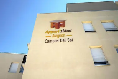 a row of tables and chairs with orange chairs at KOSY Appart'Hôtels - Campus Del Sol Esplanade in Montfavet