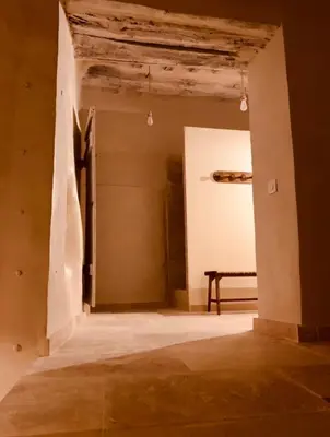 an empty room with a table and a ceiling at Le Vieux Portail in Saint-Saturnin-les-Apt