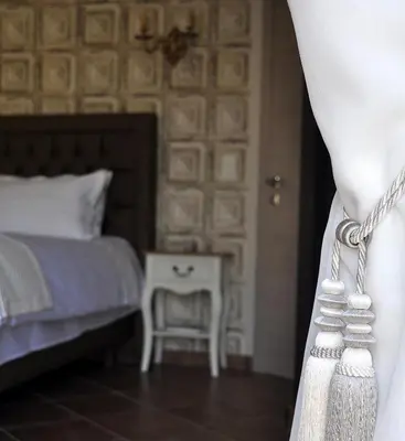 a bedroom with a bed and a table with a chair at Le Jardin des Amandiers in Châteaurenard