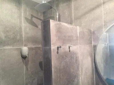 a shower in a bathroom with a mirror at Le 40 in LʼIsle-sur-la-Sorgue