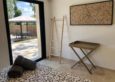 a room with a desk and a ladder and a table at In Elsama piscine chauffée in LʼIsle-sur-la-Sorgue