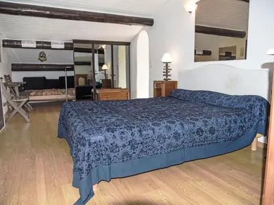 a bedroom with a bed with a blue comforter at Villa La Chênaie by Interhome in Saumane-de-Vaucluse