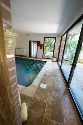 a house with a swimming pool in the middle of a room at Le Clos Violette et Le 11 D'Aglaé - Appart' Hôtel de Charme Design de Luxe in LʼIsle-sur-la-Sorgue
