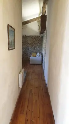 a hallway with a couch in the middle of a room at la bastide de l'adrech in Manosque