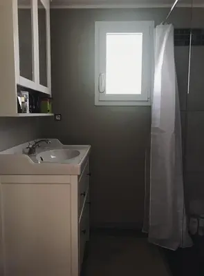 a bathroom with a sink and a window at studio avec exterieur in Eyragues