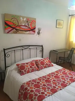 a bedroom with a bed and a table in it at Auberge de Rustréou in Rustrel