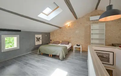 a bedroom with a bed in a brick wall at Amazing Home In Vedène in Vedène
