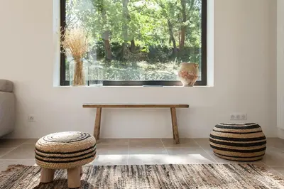 a living room with a table and a window at Les Amandiers in Bonnieux