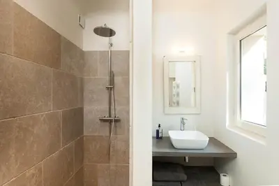 a bathroom with a sink and a shower at Les Amandiers in Bonnieux