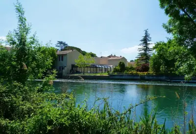 a pool of water in front of a house at Au Murmure de la Sorgue in LʼIsle-sur-la-Sorgue