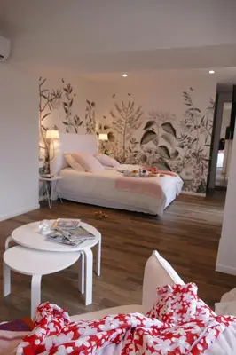 a bedroom with a large bed in a room at Maison Galatéa in Noves