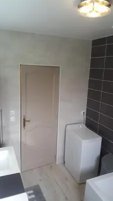 a bathroom with a toilet and a white door at Les Prairies de l'Encrême in Céreste