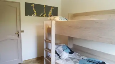 a wooden bunk bed with pillows in a room at Les Prairies de l'Encrême in Céreste