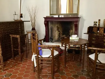 a living room with a fireplace and a table and chairs at Maison de village Novissime in Noves