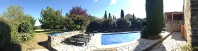 a swimming pool in a yard with chairs around it at La Fenice - Beautifully restored property with heated pool in small village in Montjustin