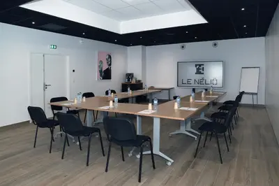 a conference room with a long table and chairs at Le Néliö in Aix-en-Provence