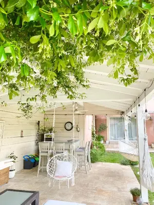 a patio with a table and chairs under a canopy at villa Luberon in Saint-Saturnin-les-Apt