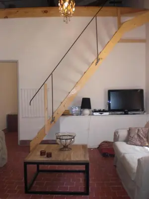 a living room with a couch and a staircase at Château de Peyrolles in Apt