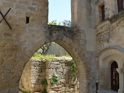 a stone building with a clock on the side of it at Provence Charm with Pool in Viens