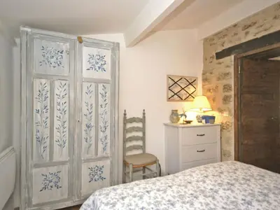 a bedroom with a bed and a wooden door at Provence Charm with Pool in Viens