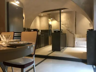 a kitchen and dining room with a table and chairs at La Calade, maison de village in Gordes