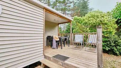 a wooden deck with chairs and a table at Domaine Les Chênes Blancs in Saint-Saturnin-les-Apt