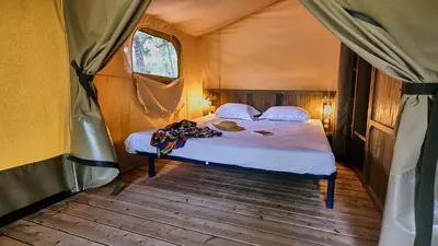 a bedroom with a bed in a tent at Domaine Les Chênes Blancs in Saint-Saturnin-les-Apt