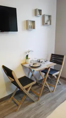 a bedroom with a large white bed with a large window at Sweet Home Studio Aix en Pce, clim,terrasse,piscine,pkg gratuit in Aix-en-Provence