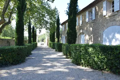 a pathway in front of a house with trees at Moulin des Gypses Gîte Les Pierres Blanches, Ventoux in Mormoiron