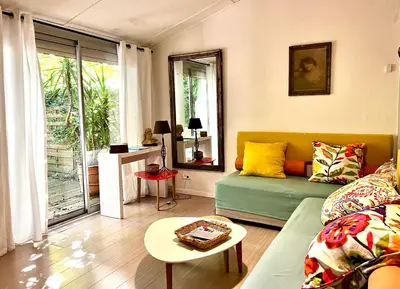 a living room with a couch and a table at Villa Melodie St Remy 6HA Piscine in Saint-Rémy-de-Provence