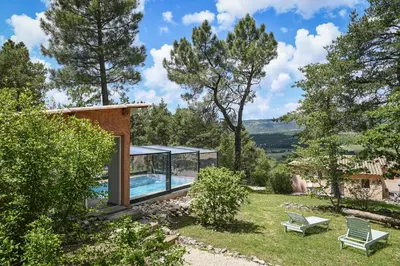 a house with a swimming pool and trees at Domaine du Val de Sault in Sault-de-Vaucluse