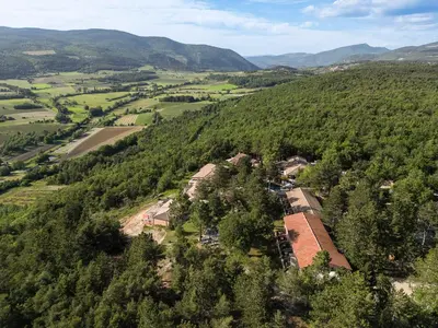 an aerial view of a house in the middle of a forest at Domaine du Val de Sault in Sault-de-Vaucluse