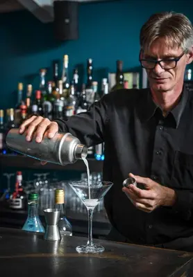 a man pours a drink into a martini glass at Domaine du Val de Sault in Sault-de-Vaucluse