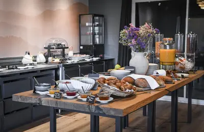 a table with bread and other food on it in a kitchen at Domaine du Val de Sault in Sault-de-Vaucluse