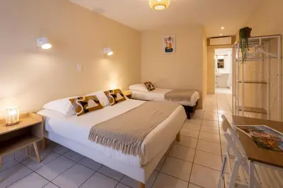 a hotel room with two beds and a table at L'Aptois Hôtel in Apt
