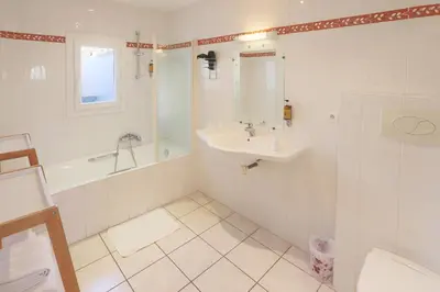 a hotel room with a bed and a window at L'Aptois Hôtel in Apt