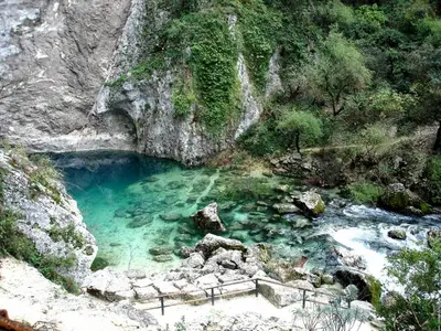 a pool of blue water in a rocky canyon at Gite des Taillades in Les Taillades