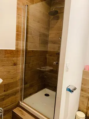 a shower with a glass door in a bathroom at Zola Studio fenêtre aveugle in Aix-en-Provence