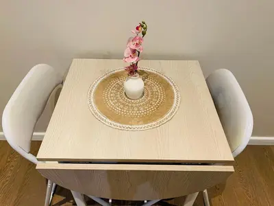 a table with a vase on top of it at Zola Studio fenêtre aveugle in Aix-en-Provence
