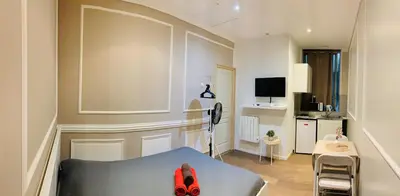 a small living room with a couch and a table at Zola Studio fenêtre aveugle in Aix-en-Provence