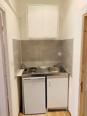 a small kitchen with a sink and a counter top at Victoire Appartement in Aix-en-Provence