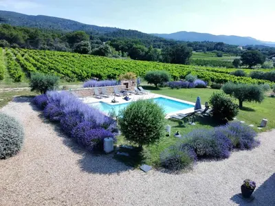 an aerial view of a garden with purple flowers and a pool at Mas Bastide st Victor à 5 mn de Lourmarin in Puyvert