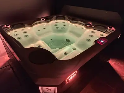 a jacuzzi tub in a dark room with lights at Les Grandes Terres - Gîtes & SPA in Mérindol