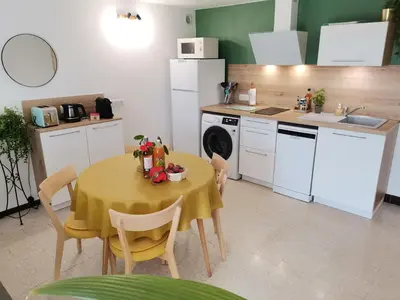 a kitchen with a table with a yellow table cloth at Gîte en Provence ''Rose'' in Modène
