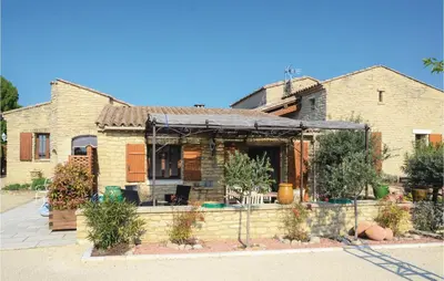 a house with a fence in front of it at Lovely Home In Gordes With Kitchen in Gordes