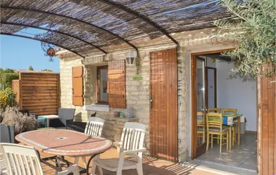a patio with a table and chairs at Lovely Home In Gordes With Kitchen in Gordes