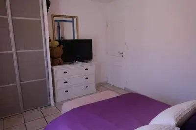 a bedroom with a bed and a tv on a dresser at pleasant one-level villa with private pool in the thor village, close to l'isle sur la sorgue - 6 persons in Le Thor